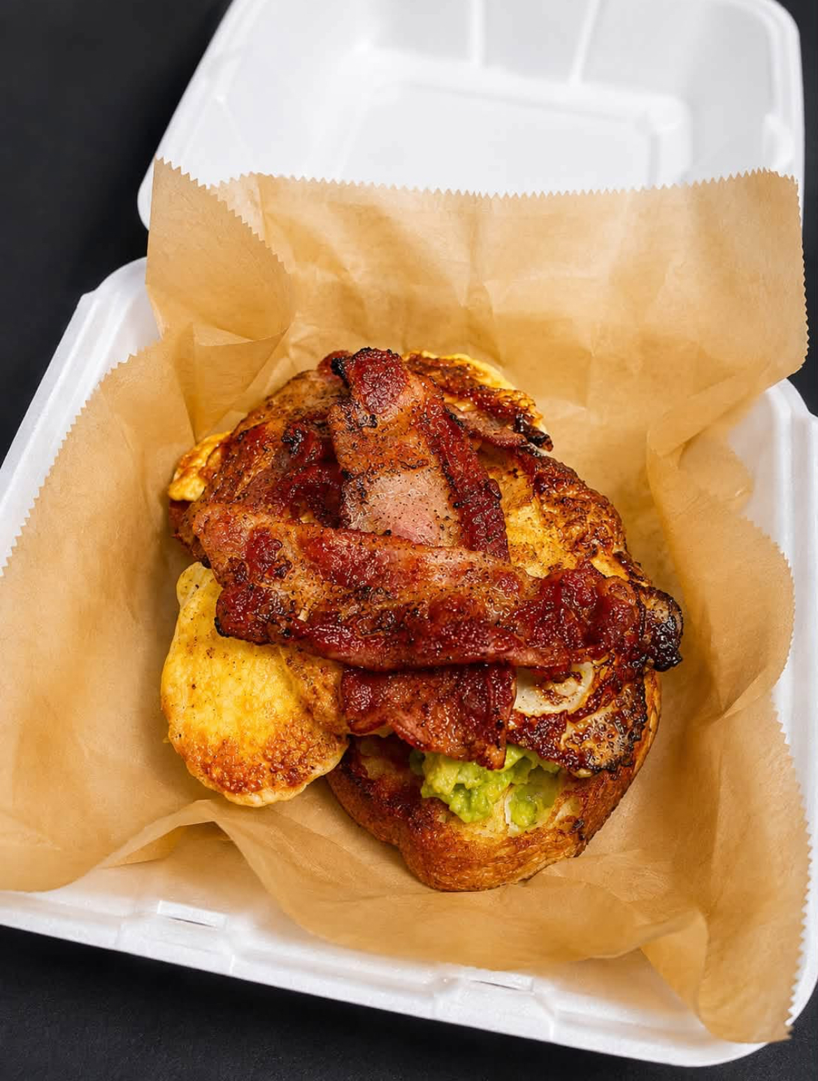 Bacon, egg and avocado sourdough breakfast sandwich to go